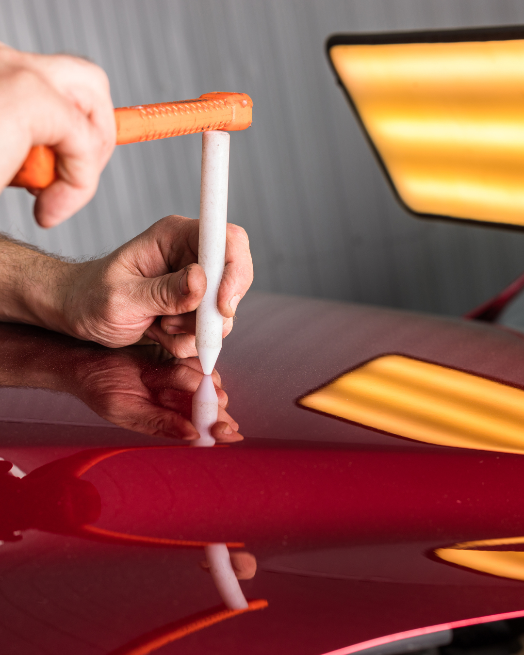 Technician repairing dent
